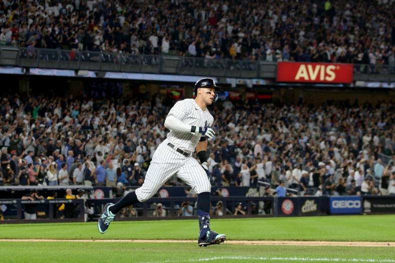 Sep 21, 2022; Bronx, New York, USA; New York Yankees right fielder Aaron Judge (99) runs to first base after hitting a ground rule double against the Pittsburgh Pirates during the fifth inning at Yankee Stadium. Mandatory Credit: Brad Penner-USA TODAY Sports