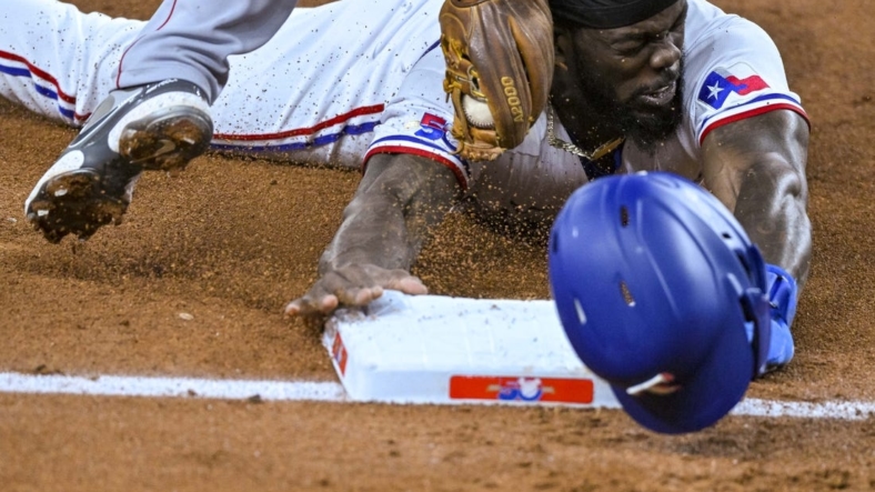Sep 21, 2022; Arlington, Texas, USA; Texas Rangers designated hitter Adolis Garcia (53) is tagged out after he caught attempting to steal third base during the third inning against the Los Angeles Angels at Globe Life Field. Mandatory Credit: Jerome Miron-USA TODAY Sports
