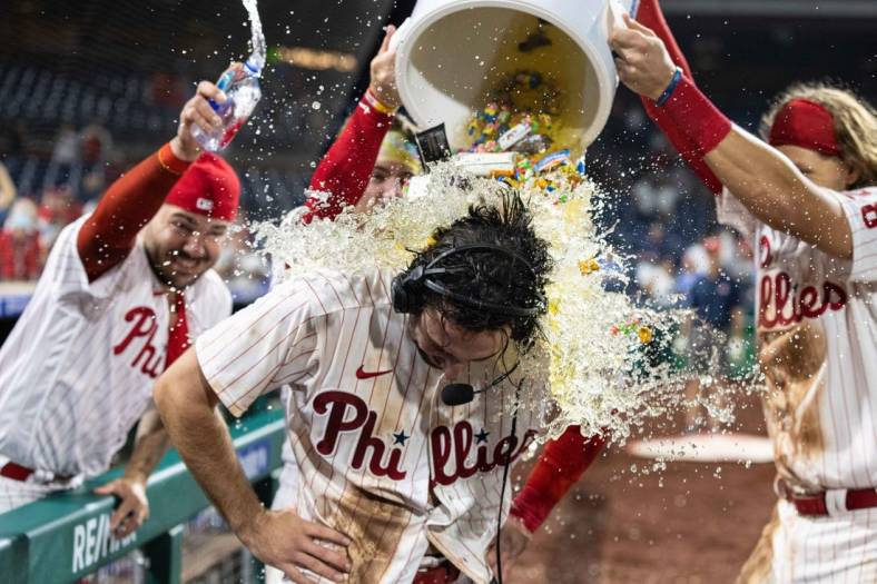 Sep 21, 2022; Philadelphia, Pennsylvania, USA; Philadelphia Phillies center fielder Matt Vierling (19) is doused by liquid and bubble gum after hitting a walk off RBI single during the tenth inning against the Toronto Blue Jays at Citizens Bank Park. Mandatory Credit: Bill Streicher-USA TODAY Sports