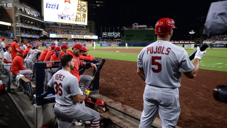Sep 21, 2022; San Diego, California, USA; St. Louis Cardinals designated hitter Albert Pujols (5) and right fielder Juan Yepez (36) look on from the dugout during the fourth inning against the San Diego Padres at Petco Park. Mandatory Credit: Orlando Ramirez-USA TODAY Sports