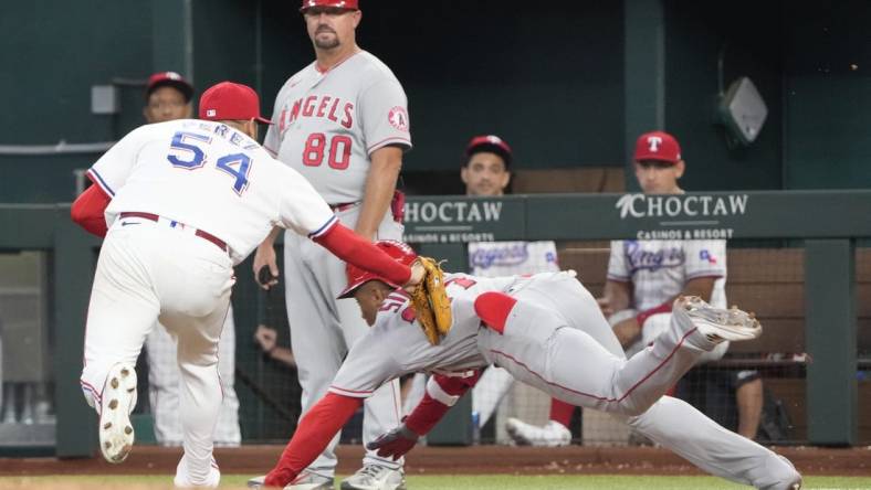 Sep 22, 2022; Arlington, Texas, USA; Texas Rangers starting pitcher Martin Perez (54) tags out Los Angeles Angels center fielder Magneuris Sierra (37) during the fourth inning at Globe Life Field. Mandatory Credit: Jim Cowsert-USA TODAY Sports