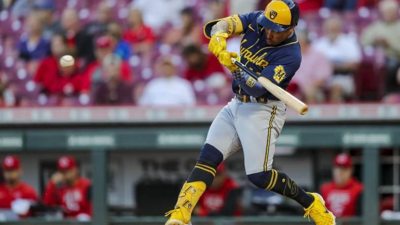 Sep 22, 2022; Cincinnati, Ohio, USA; Milwaukee Brewers second baseman Kolten Wong (16) hits a two-run home run in the second inning against the Cincinnati Reds at Great American Ball Park. Mandatory Credit: Katie Stratman-USA TODAY Sports