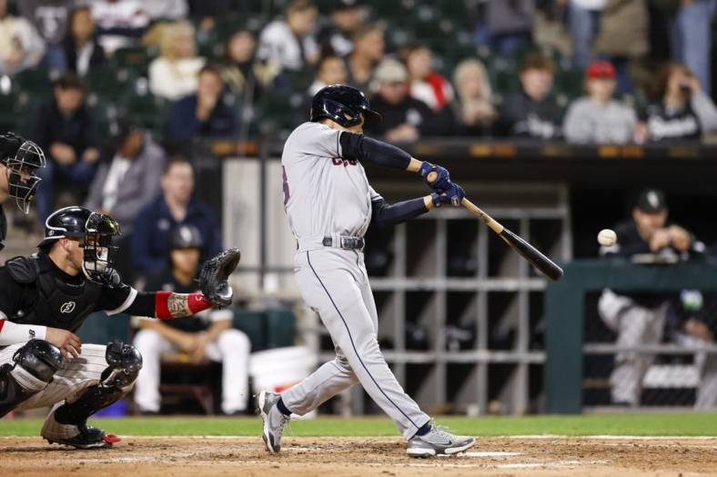 Sep 22, 2022; Chicago, Illinois, USA; Cleveland Guardians left fielder Steven Kwan (38) hits an RBI triple against the Chicago White Sox during the fifth inning at Guaranteed Rate Field. Mandatory Credit: Kamil Krzaczynski-USA TODAY Sports