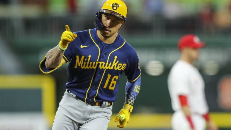 Sep 22, 2022; Cincinnati, Ohio, USA; Milwaukee Brewers second baseman Kolten Wong (16) reacts after hitting a two-run home run in the sixth inning against the Cincinnati Reds at Great American Ball Park. Mandatory Credit: Katie Stratman-USA TODAY Sports