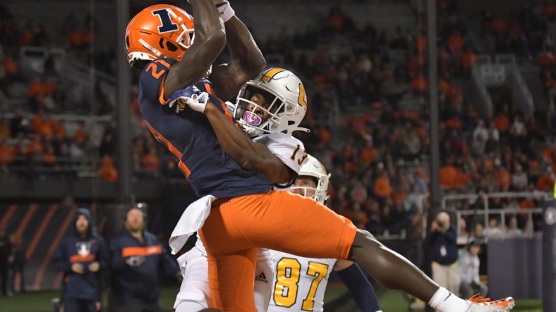 Sep 22, 2022; Champaign, Illinois, USA; Illinois Fighting Illini defensive back Jartavius Martin (21) intercepts the ball in the end zone on a pass intended for Chattanooga Mocs wide receiver Tyron Arnett (13) during the first half at Memorial Stadium. Mandatory Credit: Ron Johnson-USA TODAY Sports