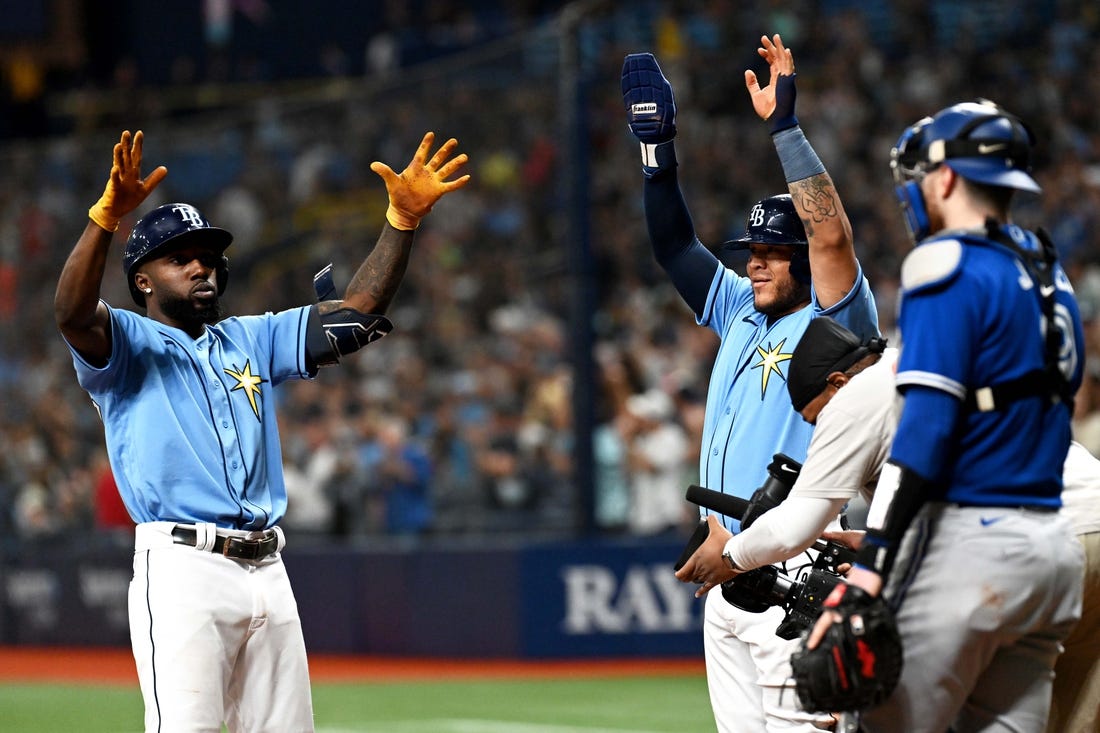 Sep 23, 2022; St. Petersburg, Florida, USA; Tampa Bay Rays left fielder Randy Arozarena (left) and designated hitter Harold Ramirez (43) celebrate after scoring in the fifth inning against the Toronto Blue Jays at Tropicana Field. Mandatory Credit: Jonathan Dyer-USA TODAY Sports