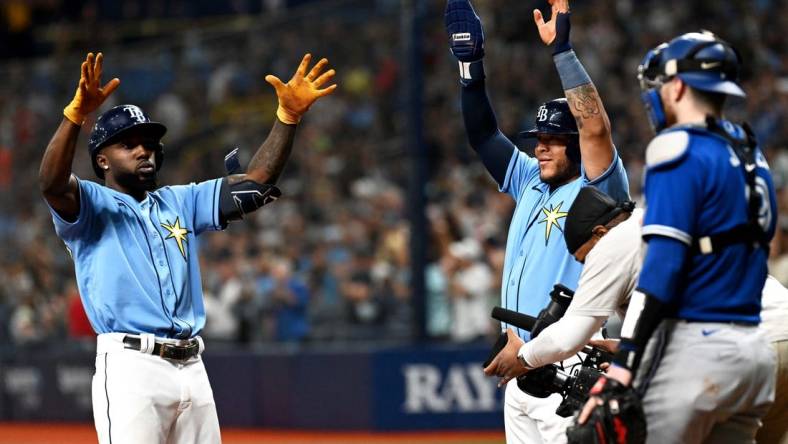 Sep 23, 2022; St. Petersburg, Florida, USA; Tampa Bay Rays left fielder Randy Arozarena (left) and designated hitter Harold Ramirez (43) celebrate after scoring in the fifth inning against the Toronto Blue Jays at Tropicana Field. Mandatory Credit: Jonathan Dyer-USA TODAY Sports