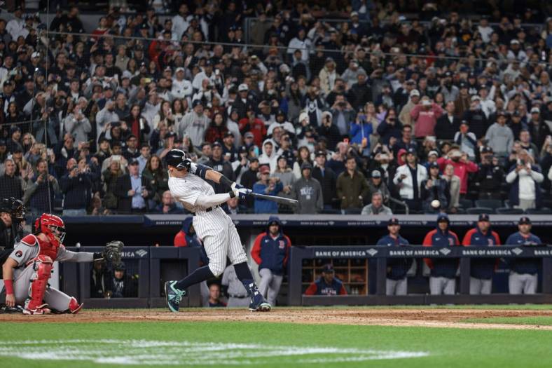 Sep 23, 2022; Bronx, New York, USA; New York Yankees center fielder Aaron Judge (99) singles during the seventh inning against the Boston Red Sox at Yankee Stadium. Mandatory Credit: Vincent Carchietta-USA TODAY Sports
