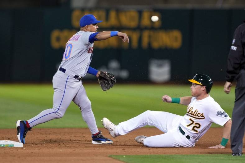 Sep 23, 2022; Oakland, California, USA; New York Mets third baseman Eduardo Escobar (10) throws the ball to first base to complete a double play after forcing out Oakland Athletics right fielder Conner Capel (72) during the fifth inning at RingCentral Coliseum. Mandatory Credit: Darren Yamashita-USA TODAY Sports