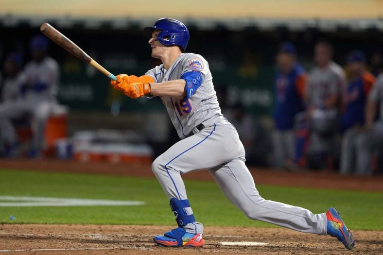 Sep 23, 2022; Oakland, California, USA; New York Mets left fielder Mark Canha (19) hits a double against the Oakland Athletics during the eighth inning at RingCentral Coliseum. Mandatory Credit: Darren Yamashita-USA TODAY Sports