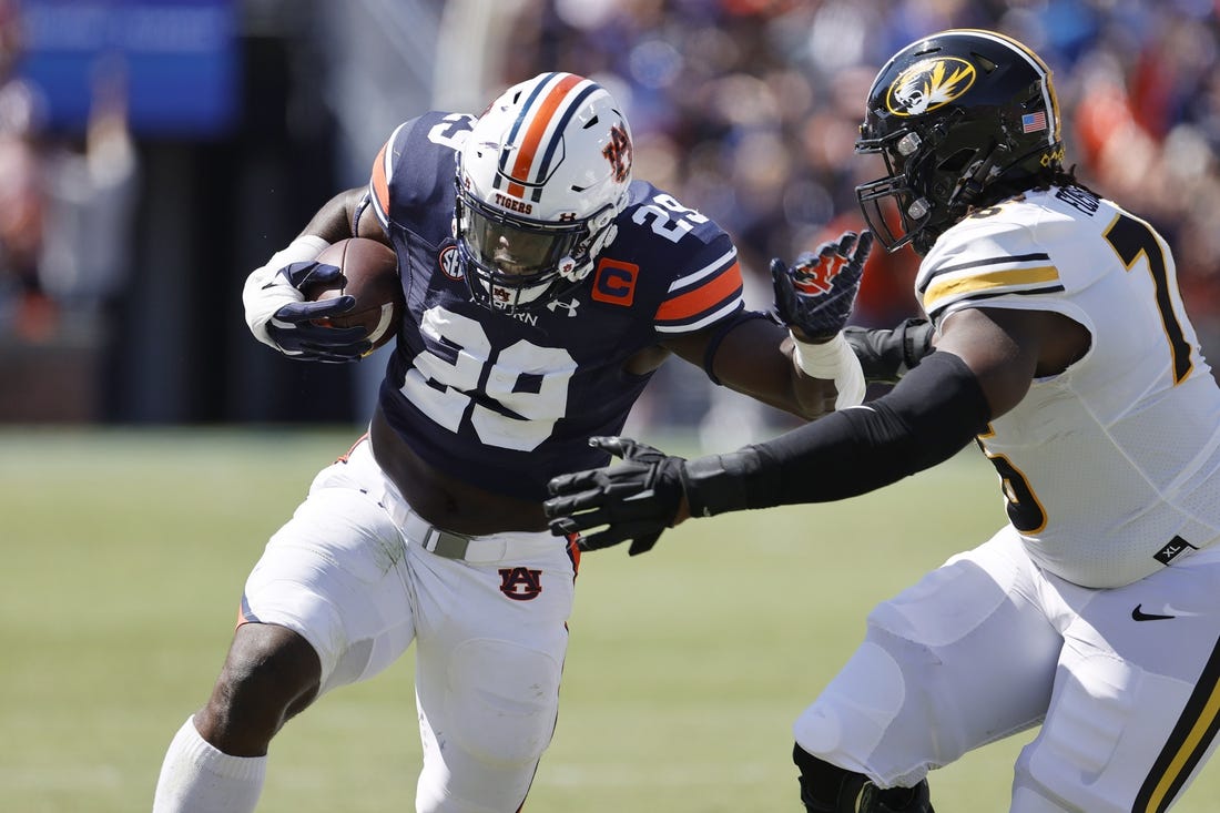 Sep 24, 2022; Auburn, Alabama, USA;  Auburn Tigers linebacker Derick Hall (29) returns an interception as Missouri Tigers offensive lineman Javon Foster (76) goes for the tackle during the first quarter at Jordan-Hare Stadium. Mandatory Credit: John Reed-USA TODAY Sports