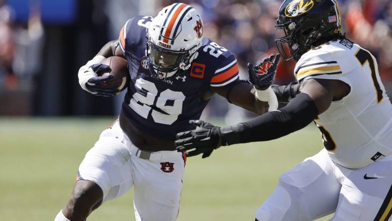 Sep 24, 2022; Auburn, Alabama, USA;  Auburn Tigers linebacker Derick Hall (29) returns an interception as Missouri Tigers offensive lineman Javon Foster (76) goes for the tackle during the first quarter at Jordan-Hare Stadium. Mandatory Credit: John Reed-USA TODAY Sports