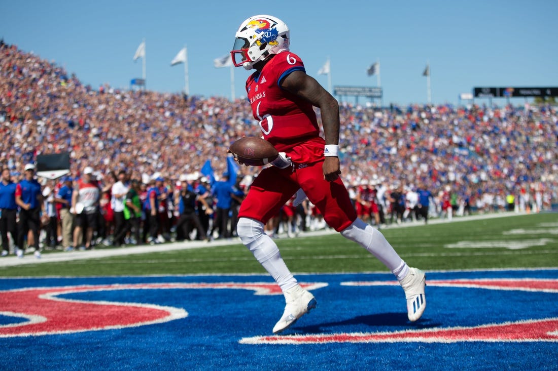 Kansas junior quarterback Jalon Daniels (6) runs in for a touchdown in the third quarter of Saturday's game against Duke at David Booth Kansas Memorial Stadium Saturday.