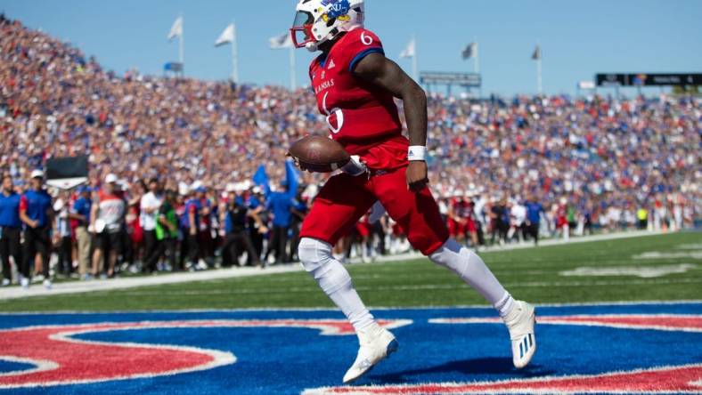 Kansas junior quarterback Jalon Daniels (6) runs in for a touchdown in the third quarter of Saturday's game against Duke at David Booth Kansas Memorial Stadium Saturday.