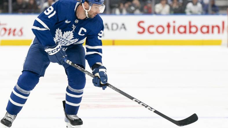 Sep 24, 2022; Toronto, Ontario, CAN; Toronto Maple Leafs center John Tavares (91) skates with the puck against the Ottawa Senators during the third period at Scotiabank Arena. Mandatory Credit: Nick Turchiaro-USA TODAY Sports