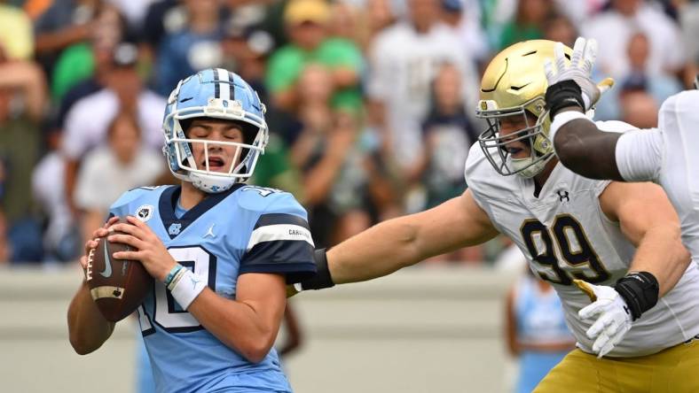 Sep 24, 2022; Chapel Hill, North Carolina, USA; North Carolina Tar Heels quarterback Drake Maye (10) is sacked by Notre Dame Fighting Irish defensive lineman Rylie Mills (99) in the first quarter at Kenan Memorial Stadium. Mandatory Credit: Bob Donnan-USA TODAY Sports