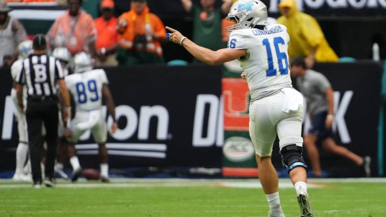 Sep 24, 2022; Miami Gardens, Florida, USA; Middle Tennessee Blue Raiders quarterback Chase Cunningham (16) celebrates after throwing a touchdown pass against the Miami Hurricanes during the first half at Hard Rock Stadium. Mandatory Credit: Jasen Vinlove-USA TODAY Sports