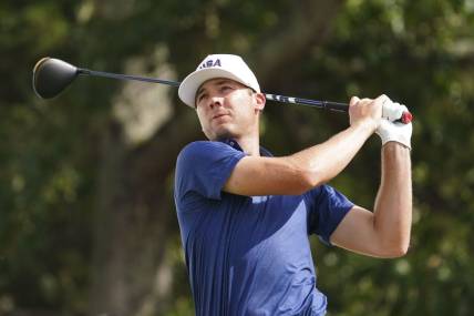 Sep 24, 2022; Charlotte, North Carolina, USA; Team USA golfer Sam Burns hits his tee shot on the 12th hole during the four-ball match play of the Presidents Cup golf tournament at Quail Hollow Club. Mandatory Credit: Peter Casey-USA TODAY Sports