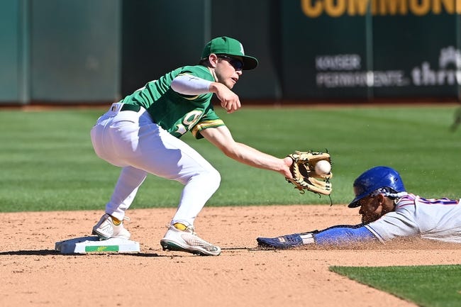 Sep 24, 2022; Oakland, California, USA; Oakland Athletics shortstop Nick Allen (2) tags out New York Mets shortstop Francisco Lindor (12) at second base during the sixth inning at RingCentral Coliseum. Mandatory Credit: Robert Edwards-USA TODAY Sports