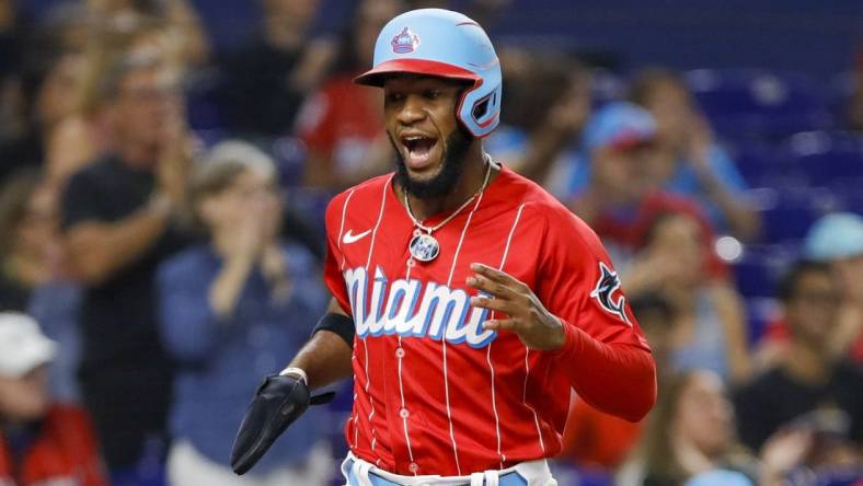 Sep 24, 2022; Miami, Florida, USA; Miami Marlins center fielder Bryan De La Cruz (14) scores after a double by shortstop Miguel Rojas (not pictured) during the sixth inning against the Washington Nationals at loanDepot Park. Mandatory Credit: Sam Navarro-USA TODAY Sports