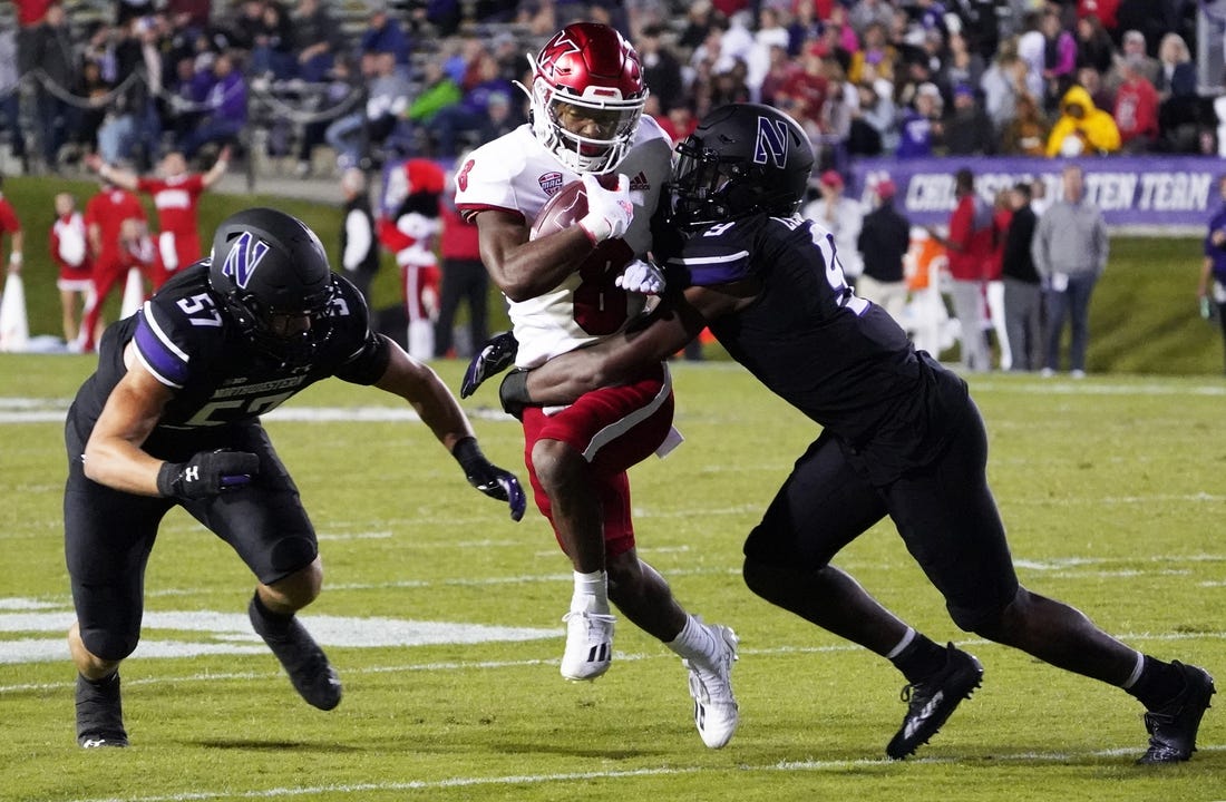 Sep 24, 2022; Evanston, Illinois, USA; Northwestern Wildcats defensive back Jeremiah Lewis (9) tackles Miami (Ohio) Redhawks running back Kevin Davis (8) during the first half at Ryan Field. Mandatory Credit: David Banks-USA TODAY Sports