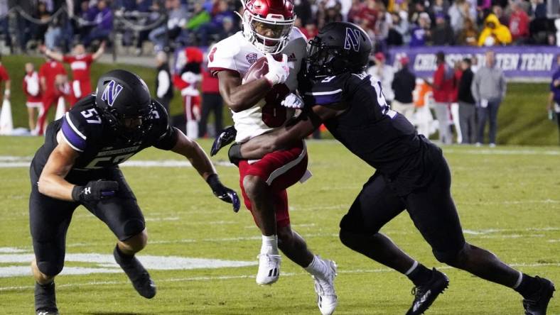 Sep 24, 2022; Evanston, Illinois, USA; Northwestern Wildcats defensive back Jeremiah Lewis (9) tackles Miami (Ohio) Redhawks running back Kevin Davis (8) during the first half at Ryan Field. Mandatory Credit: David Banks-USA TODAY Sports