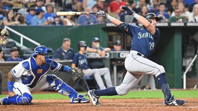 Sep 24, 2022; Kansas City, Missouri, USA;  Seattle Mariners pinch hitter Cal Raleigh (29) hits a two-run home run during the sixth inning against the Kansas City Royals at Kauffman Stadium. Mandatory Credit: Peter Aiken-USA TODAY Sports