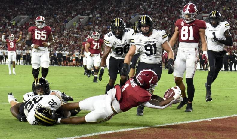 Sep 24, 2022; Tuscaloosa, Alabama, USA;  Alabama Crimson Tide running back Jahmyr Gibbs (1) stretches across the goal line for a touchdown against Vanderbilt Commodores linebacker Ethan Barr (32) at Bryant-Denny Stadium. Mandatory Credit: Gary Cosby Jr.-USA TODAY Sports