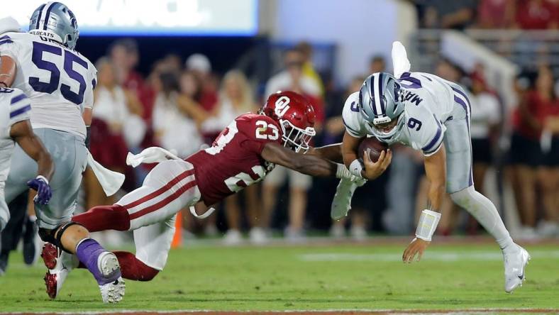 Oklahoma's DaShaun White (23) brings down Kansas State's Adrian Martinez (9) during a college football game between the University of Oklahoma Sooners (OU) and the Kansas State Wildcats at Gaylord Family - Oklahoma Memorial Stadium in Norman, Okla., Saturday, Sept. 24, 2022.

Ou Vs Kansas State