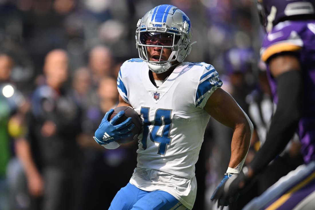 Sep 25, 2022; Minneapolis, Minnesota, USA; Detroit Lions wide receiver Amon-Ra St. Brown (14) runs the ball after a catch from quarterback Jared Goff (not pictured) against the Minnesota Vikings during the first quarter at U.S. Bank Stadium. Mandatory Credit: Jeffrey Becker-USA TODAY Sports