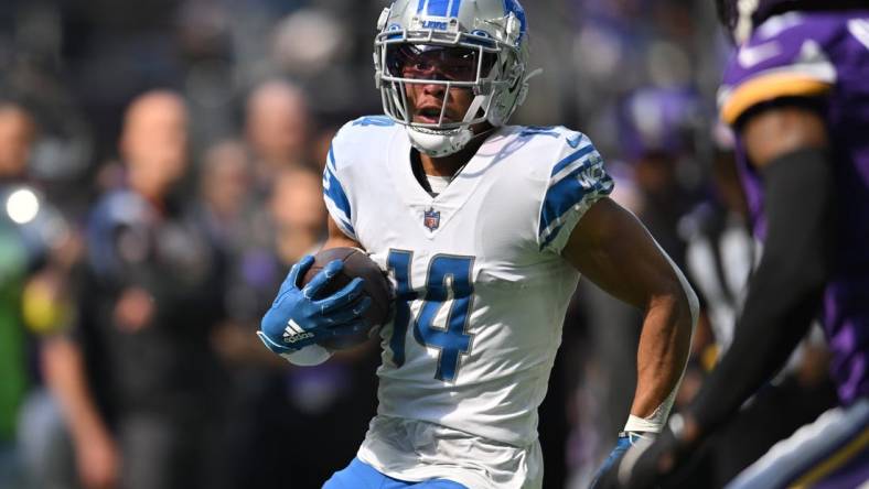 Sep 25, 2022; Minneapolis, Minnesota, USA; Detroit Lions wide receiver Amon-Ra St. Brown (14) runs the ball after a catch from quarterback Jared Goff (not pictured) against the Minnesota Vikings during the first quarter at U.S. Bank Stadium. Mandatory Credit: Jeffrey Becker-USA TODAY Sports