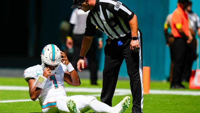 Sep 25, 2022; Miami Gardens, Florida, USA; Miami Dolphins quarterback Tua Tagovailoa (1) lays on the field after apparent injury against the Buffalo Bills during the first quarter at Hard Rock Stadium. Mandatory Credit: Rich Storry-USA TODAY Sports