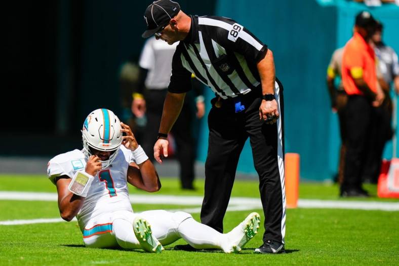 Sep 25, 2022; Miami Gardens, Florida, USA; Miami Dolphins quarterback Tua Tagovailoa (1) lays on the field after apparent injury against the Buffalo Bills during the first quarter at Hard Rock Stadium. Mandatory Credit: Rich Storry-USA TODAY Sports