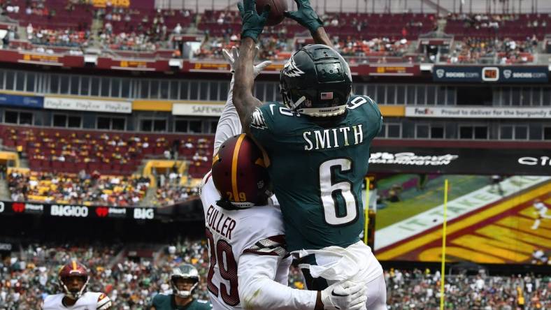 Sep 25, 2022; Landover, Maryland, USA; Philadelphia Eagles wide receiver DeVonta Smith (6) scores a touchdown over Washington Commanders cornerback Kendall Fuller (29) before the game between the Washington Commanders and the Philadelphia Eagles at FedExField. Mandatory Credit: Brad Mills-USA TODAY Sports