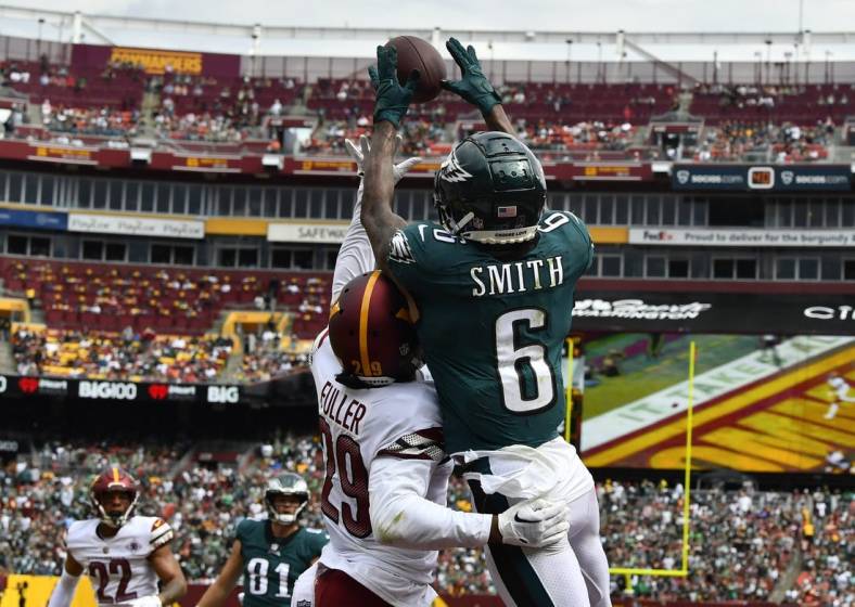 Sep 25, 2022; Landover, Maryland, USA; Philadelphia Eagles wide receiver DeVonta Smith (6) scores a touchdown over Washington Commanders cornerback Kendall Fuller (29) before the game between the Washington Commanders and the Philadelphia Eagles at FedExField. Mandatory Credit: Brad Mills-USA TODAY Sports