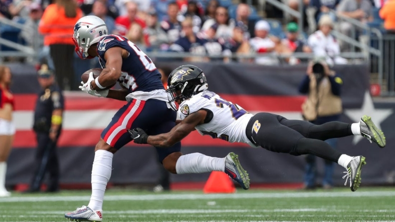 Sep 25, 2022; Foxborough, Massachusetts, USA; Baltimore Ravens cornerback Damarion Williams (22) tackles New England Patriots receiver Kendrick Bourne (84) during the first half at Gillette Stadium. Mandatory Credit: Paul Rutherford-USA TODAY Sports