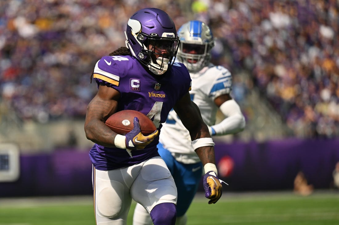 Sep 25, 2022; Minneapolis, Minnesota, USA; Minnesota Vikings running back Dalvin Cook (4) runs the ball as Detroit Lions cornerback Amani Oruwariye (24) pursues during the second quarter at U.S. Bank Stadium. Mandatory Credit: Jeffrey Becker-USA TODAY Sports