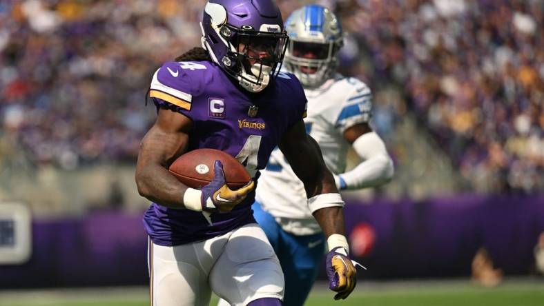 Sep 25, 2022; Minneapolis, Minnesota, USA; Minnesota Vikings running back Dalvin Cook (4) runs the ball as Detroit Lions cornerback Amani Oruwariye (24) pursues during the second quarter at U.S. Bank Stadium. Mandatory Credit: Jeffrey Becker-USA TODAY Sports