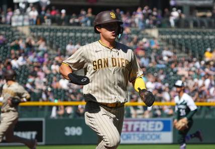 Sep 25, 2022; Denver, Colorado, USA; San Diego Padres shortstop Ha-Seong Kim (7) scores a run in the first inning against the Colorado Rockies at Coors Field. Mandatory Credit: Ron Chenoy-USA TODAY Sports