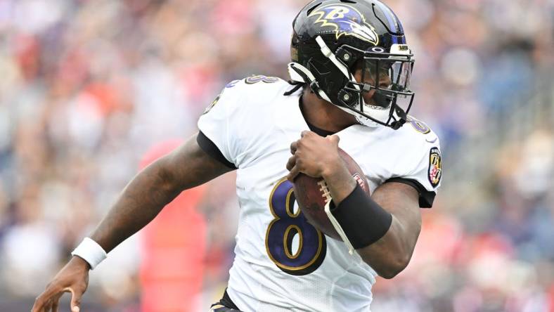 Sep 25, 2022; Foxborough, Massachusetts, USA; Baltimore Ravens quarterback Lamar Jackson (8) runs with ball during the second half of a game against the New England Patriots at Gillette Stadium. Mandatory Credit: Brian Fluharty-USA TODAY Sports