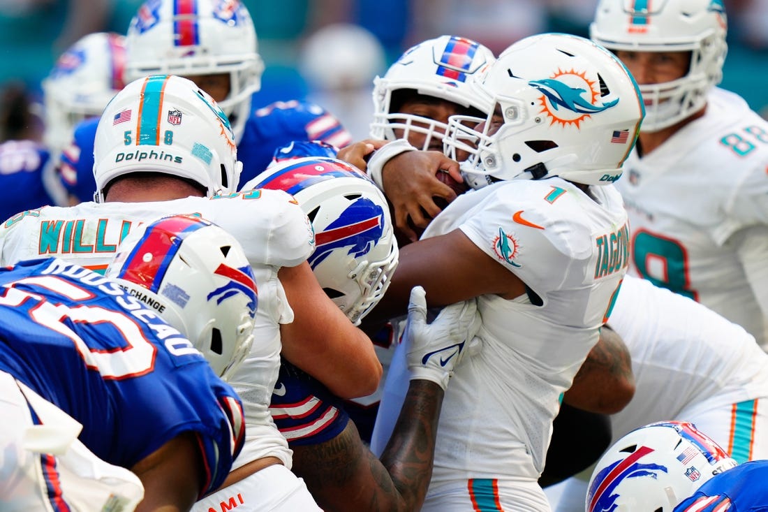 Sep 25, 2022; Miami Gardens, Florida, USA; Miami Dolphins quarterback Tua Tagovailoa (1) pushes the ball against the Buffalo Bills during the second half at Hard Rock Stadium. Mandatory Credit: Rich Storry-USA TODAY Sports