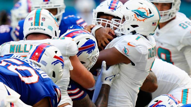 Sep 25, 2022; Miami Gardens, Florida, USA; Miami Dolphins quarterback Tua Tagovailoa (1) pushes the ball against the Buffalo Bills during the second half at Hard Rock Stadium. Mandatory Credit: Rich Storry-USA TODAY Sports