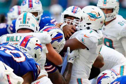 Sep 25, 2022; Miami Gardens, Florida, USA; Miami Dolphins quarterback Tua Tagovailoa (1) pushes the ball against the Buffalo Bills during the second half at Hard Rock Stadium. Mandatory Credit: Rich Storry-USA TODAY Sports