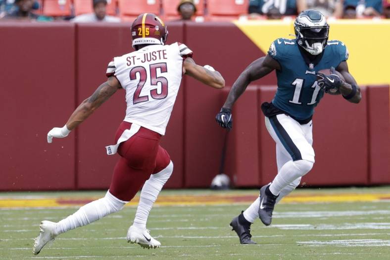 Sep 25, 2022; Landover, Maryland, USA; Philadelphia Eagles wide receiver A.J. Brown (11) runs with the ball as Washington Commanders cornerback Benjamin St-Juste (25) chases during the second quarter at FedExField. Mandatory Credit: Geoff Burke-USA TODAY Sports