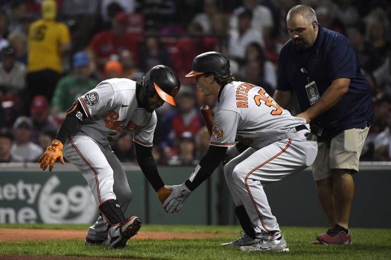 Sep 26, 2022; Boston, Massachusetts, USA; Baltimore Orioles center fielder Cedric Mullins (left) celebrates his home run with catcher Adley Rutschman (35) during the first inning against the Boston Red Sox at Fenway Park. Mandatory Credit: Bob DeChiara-USA TODAY Sports