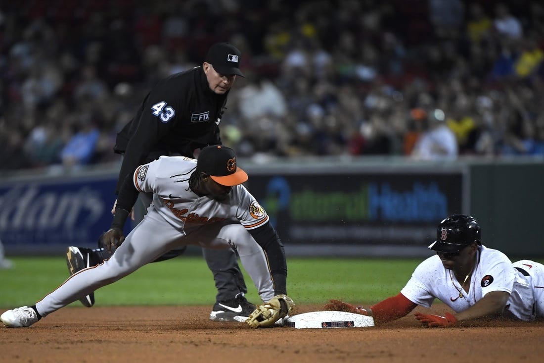 Sep 26, 2022; Boston, Massachusetts, USA; Boston Red Sox third baseman Rafael Devers (11) slides safely into second base ahead of the tag of Baltimore Orioles shortstop Jorge Mateo (3) during the first inning at Fenway Park. Mandatory Credit: Bob DeChiara-USA TODAY Sports