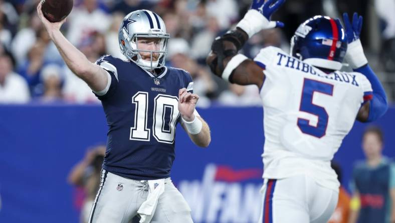 Sep 26, 2022; East Rutherford, New Jersey, USA;  Dallas Cowboys quarterback Cooper Rush (10) throws as New York Giants defensive end Kayvon Thibodeaux (5) defends during the first half at MetLife Stadium. Mandatory Credit: Brad Penner-USA TODAY Sports