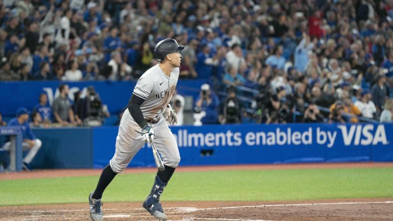 Sep 28, 2022; Toronto, Ontario, CAN; New York Yankees designated hitter Aaron Judge (99) hits his 61st home run scoring two runs against the Toronto Blue Jays during the seventh inning at Rogers Centre. Mandatory Credit: Nick Turchiaro-USA TODAY Sports