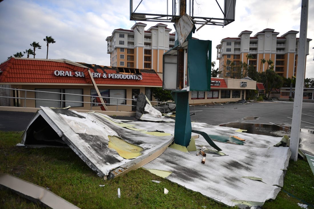 Roofing from a shopping center is wrapped around a sign at U.S. 41 and Tampa Ave. in Venice, Florida, following Hurricane Ian on Thursday, Sept. 29, 2022.

Sar Ian Venice 025