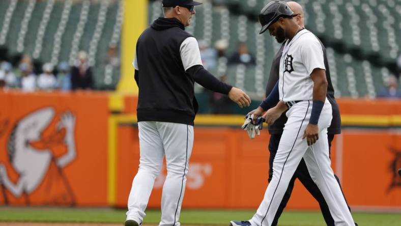 Sep 29, 2022; Detroit, Michigan, USA;  Detroit Tigers right fielder Willi Castro (9) walks off the field with Detroit Tigers manager A.J. Hinch (14) after an injury in the fourth inning against the Kansas City Royals at Comerica Park. Mandatory Credit: Rick Osentoski-USA TODAY Sports